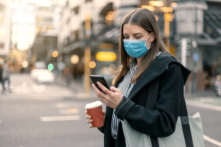 Young Woman Looking Far Away In City With Local Street Scene With Mask During Covid 19 In New Zealand - Marketing Tip...