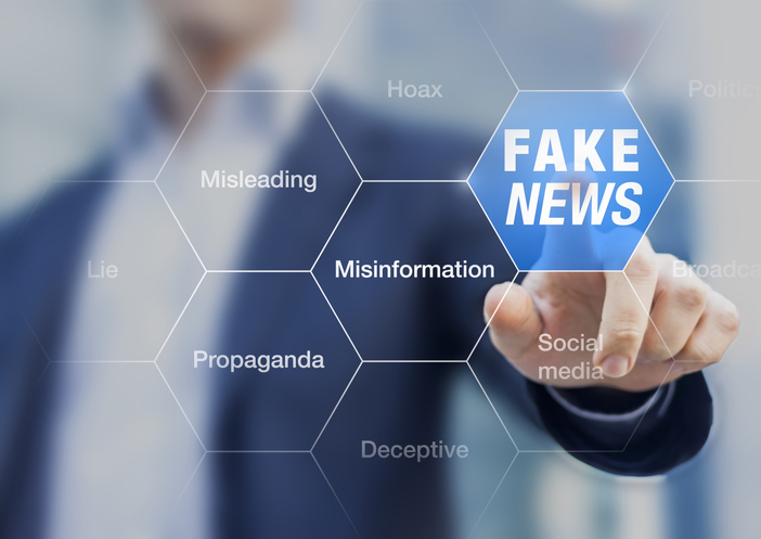 Fake News Concept With A Person Showing Misleading, Deceptive Stories, Propaganda, Lies, Fabricated Facts To Control ...