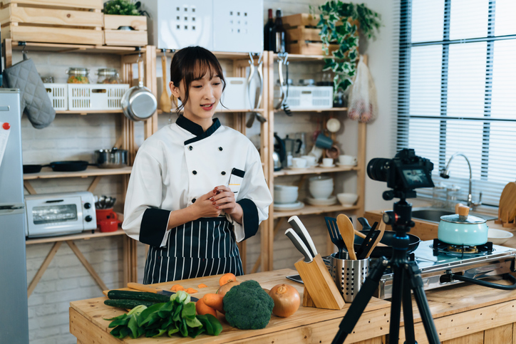 Smiling Asian Woman Chef Filming Videos For Online Culinary Class Is Holding Hands Together While Talking To Digital ...
