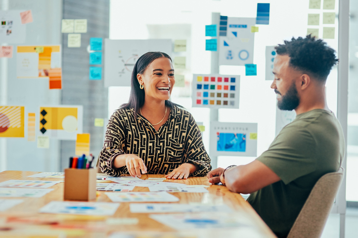 Shot Of Two Young Designers Having A Discussion In An Office - The Power Of Branding