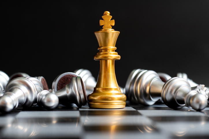 Gold King Chess Piece Win Over Lying Down Silver Pawn On Black Background - The True Power Of A Strong Brand