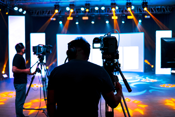 Professional Cameraman Covering On Event With A Video, Cameraman Silhouette On Live Studio News, Selective Focus - Wh...
