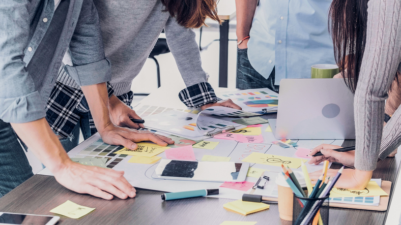 Close Up Creative Designer Applaud For Job Success At Meeting Table At Office. - Winning The Branding Battle